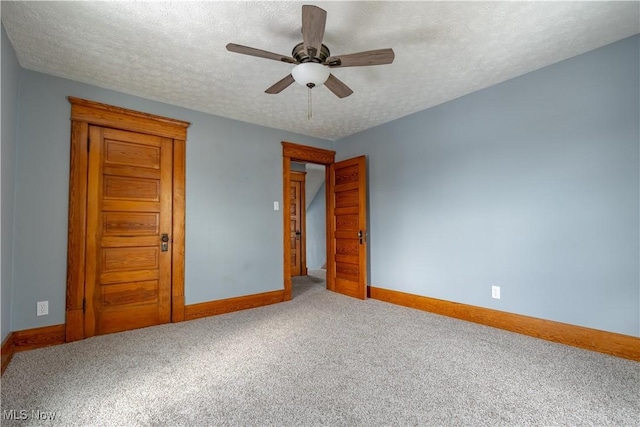 unfurnished bedroom with carpet floors, a textured ceiling, and ceiling fan