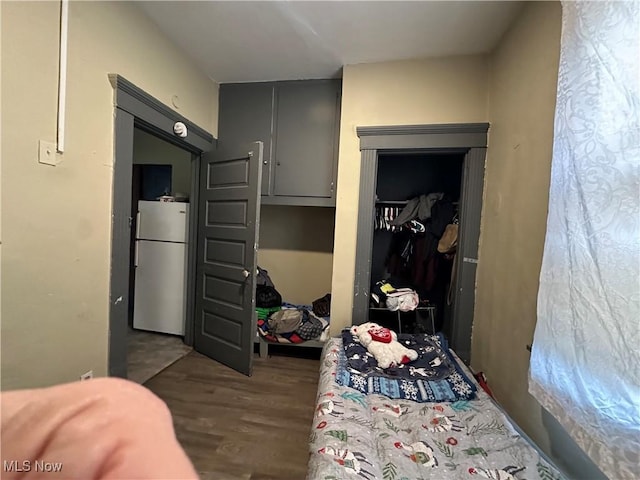 interior space featuring white refrigerator, dark hardwood / wood-style floors, and a closet