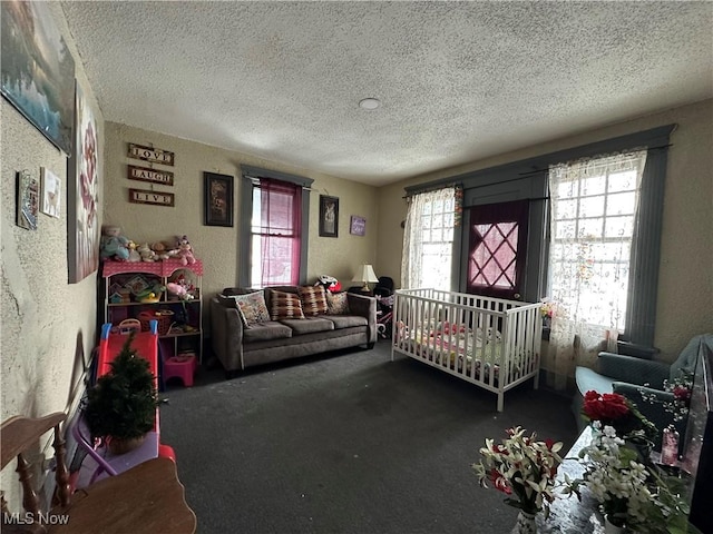 carpeted bedroom featuring a textured ceiling