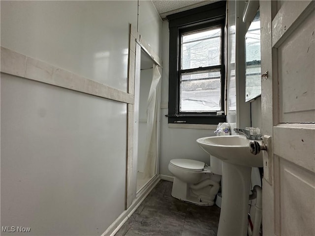 bathroom with walk in shower and toilet