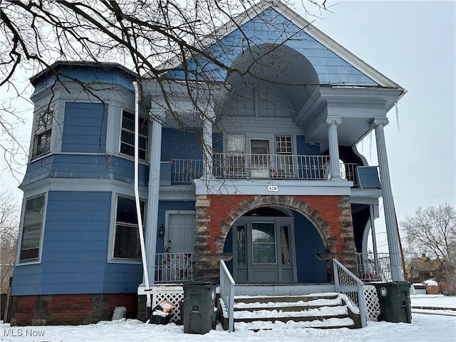 view of front of house with a porch and a balcony