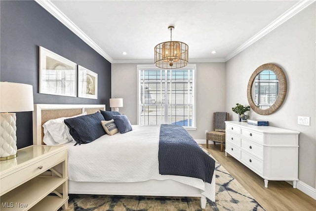 bedroom featuring crown molding, light hardwood / wood-style flooring, and a notable chandelier