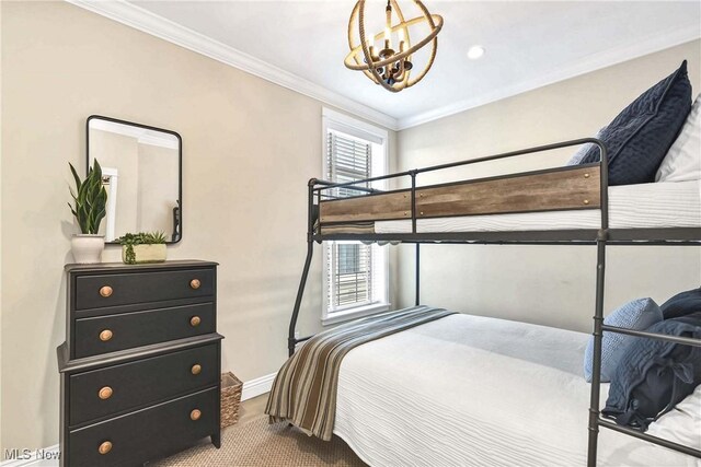 bedroom with an inviting chandelier and ornamental molding