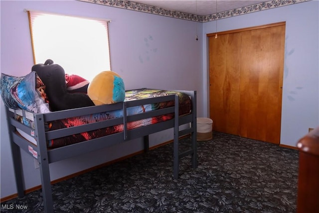 carpeted bedroom with a closet