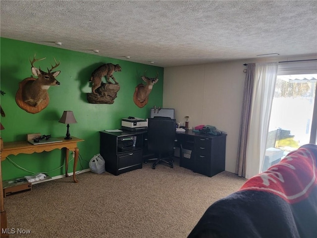 carpeted home office with a textured ceiling