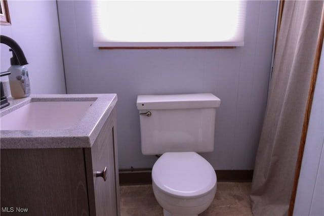 bathroom featuring vanity, a wealth of natural light, and toilet