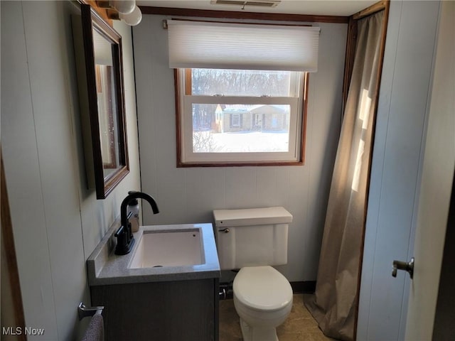 bathroom featuring vanity and toilet