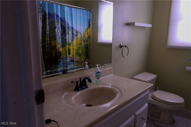 bathroom featuring vanity and toilet