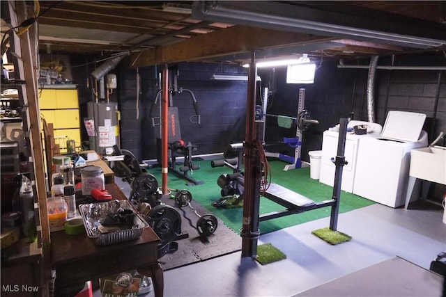 basement featuring separate washer and dryer, sink, and gas water heater