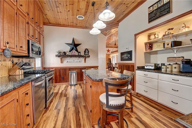 kitchen featuring a kitchen island, hanging light fixtures, light hardwood / wood-style floors, stainless steel appliances, and wooden ceiling