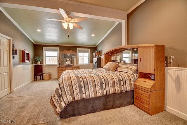 carpeted bedroom featuring lofted ceiling, crown molding, and ceiling fan