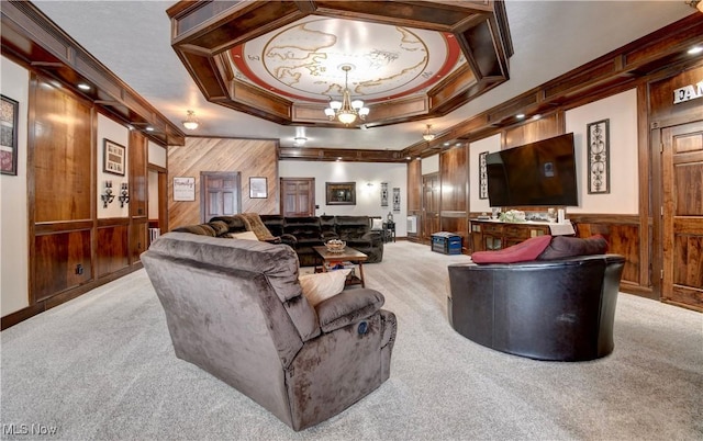 living room featuring ornamental molding, wooden walls, light carpet, and an inviting chandelier