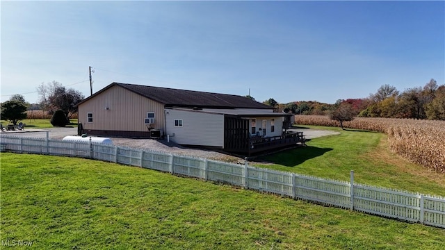 view of side of home featuring a yard and central AC unit