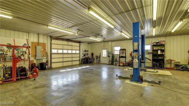 garage with electric panel and a workshop area