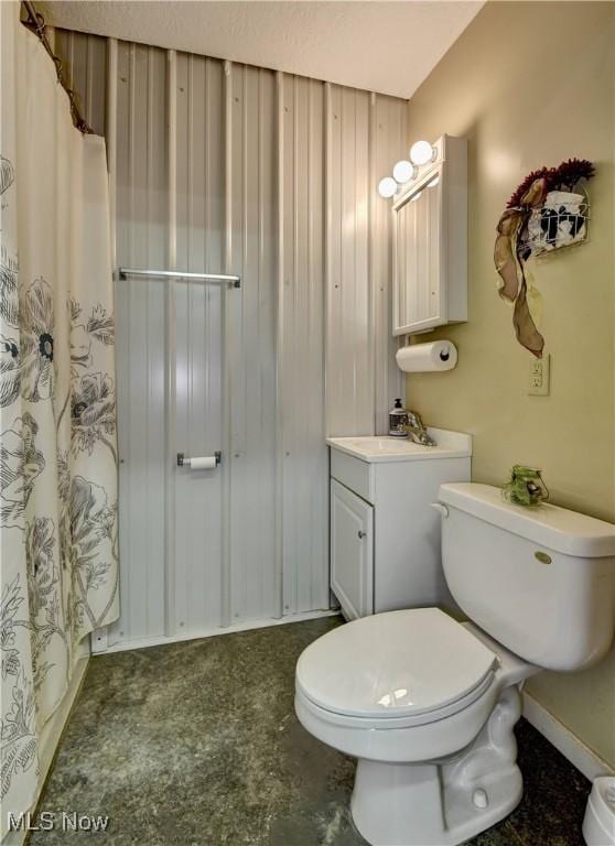 bathroom featuring vanity, curtained shower, and toilet