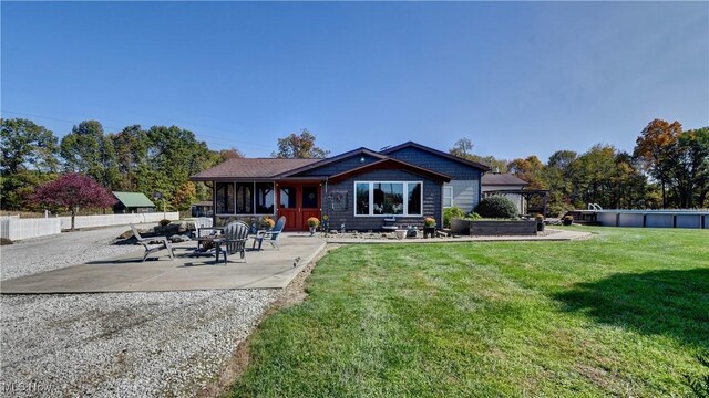 rear view of house with a gazebo, a yard, and a patio area