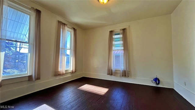 unfurnished room featuring dark hardwood / wood-style flooring