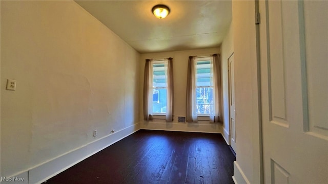 empty room featuring dark hardwood / wood-style flooring