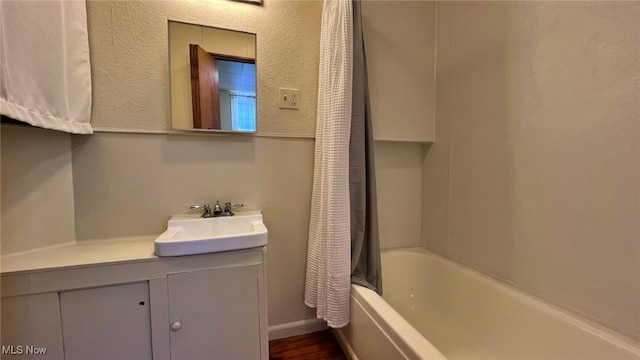 bathroom with shower / bath combination with curtain and vanity