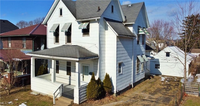 rear view of property with a porch