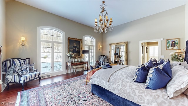 bedroom with a notable chandelier and dark hardwood / wood-style flooring