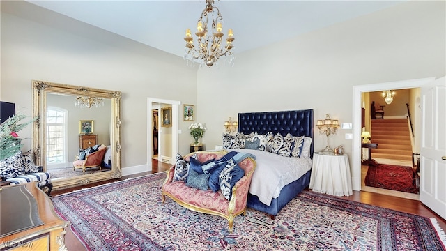 bedroom with wood-type flooring and an inviting chandelier