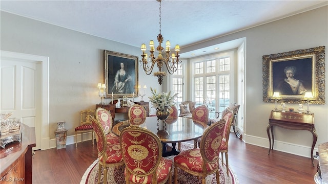 dining room with dark hardwood / wood-style flooring and a notable chandelier