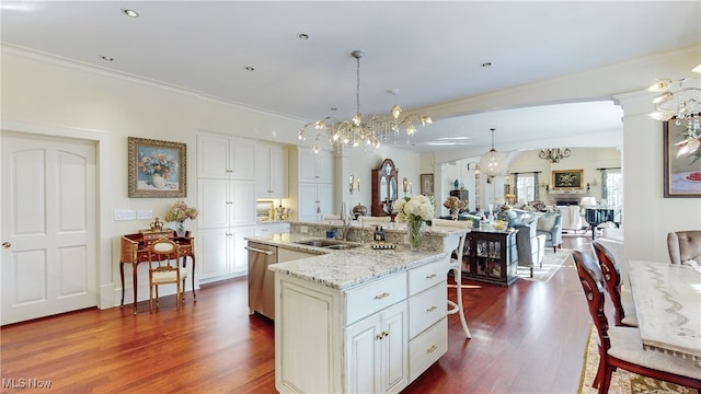 kitchen with a spacious island, white cabinetry, a kitchen breakfast bar, dark hardwood / wood-style flooring, and pendant lighting