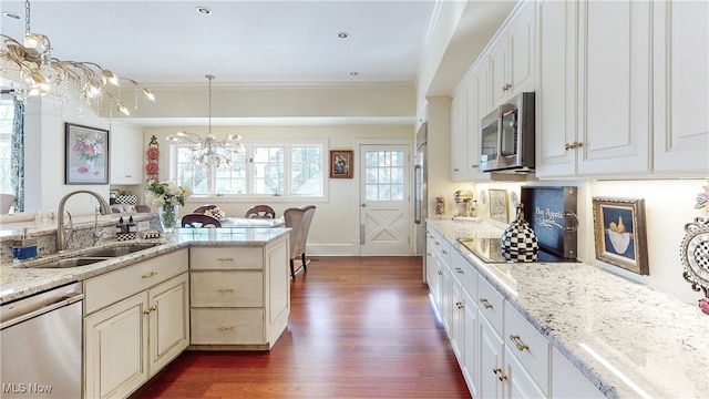 kitchen with pendant lighting, sink, a notable chandelier, and stainless steel appliances