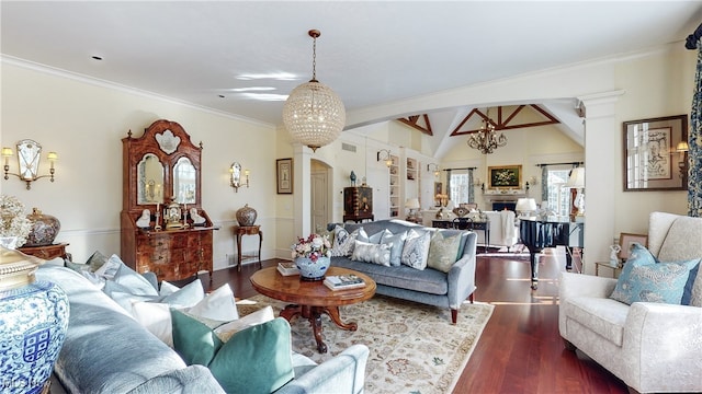 living room featuring an inviting chandelier, dark hardwood / wood-style flooring, vaulted ceiling, and decorative columns