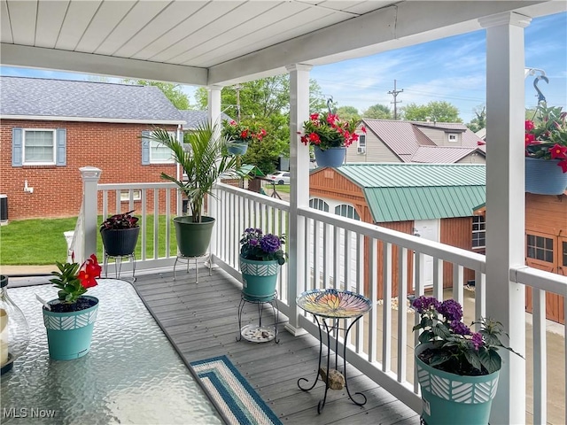 wooden deck featuring central AC unit