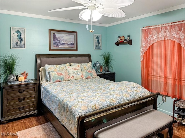 bedroom featuring ornamental molding, wood-type flooring, and ceiling fan