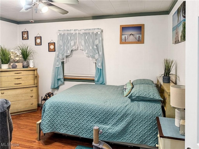 bedroom with ceiling fan and hardwood / wood-style floors