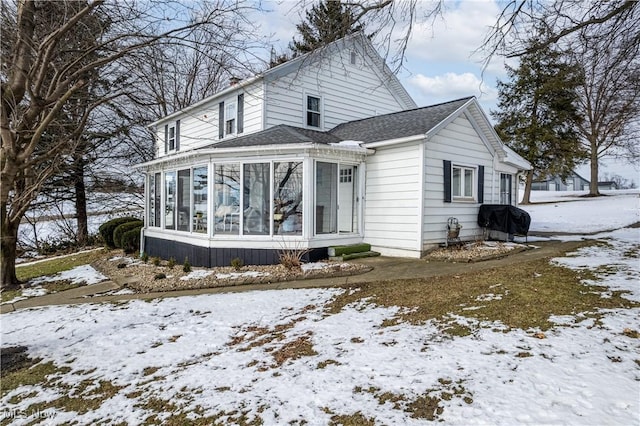 view of front facade with a sunroom