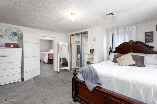 bedroom featuring light carpet, a closet, and a textured ceiling