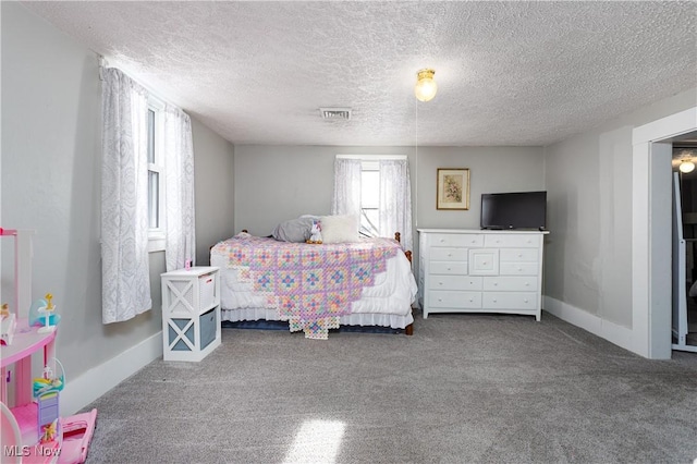 bedroom featuring carpet and a textured ceiling