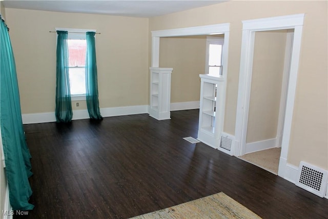 unfurnished room with dark hardwood / wood-style floors