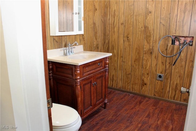 bathroom with vanity, hardwood / wood-style floors, and toilet