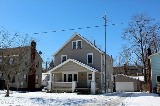 view of front property featuring an outbuilding, a garage, and covered porch