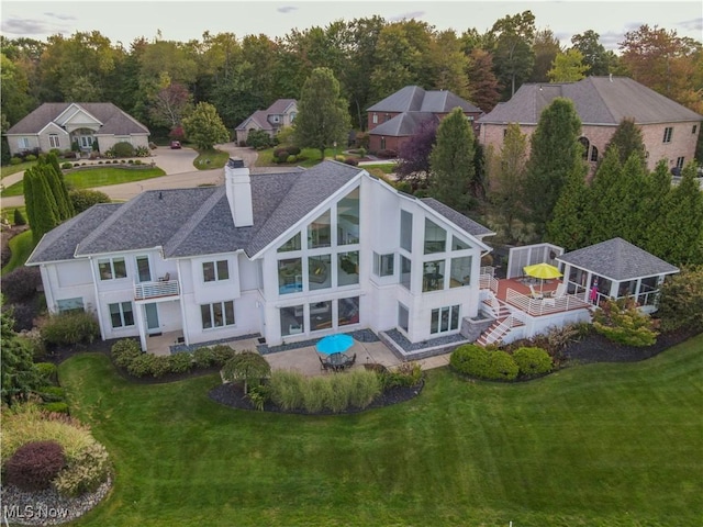 rear view of house featuring a yard