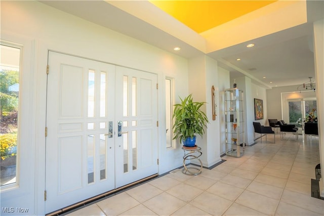 tiled foyer entrance featuring french doors