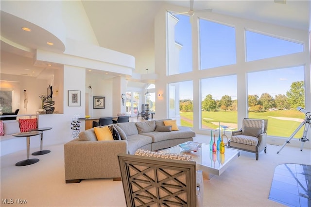 living room featuring light colored carpet and high vaulted ceiling