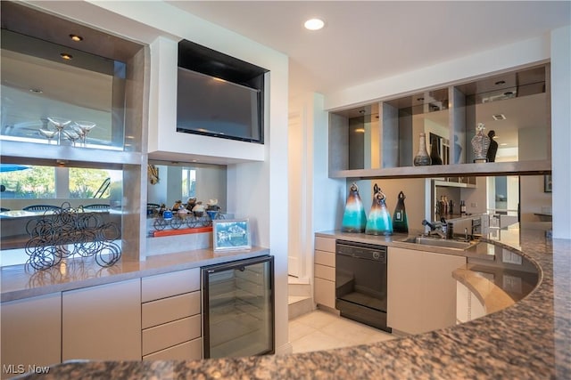 kitchen featuring sink, light tile patterned floors, dishwasher, wine cooler, and white cabinets