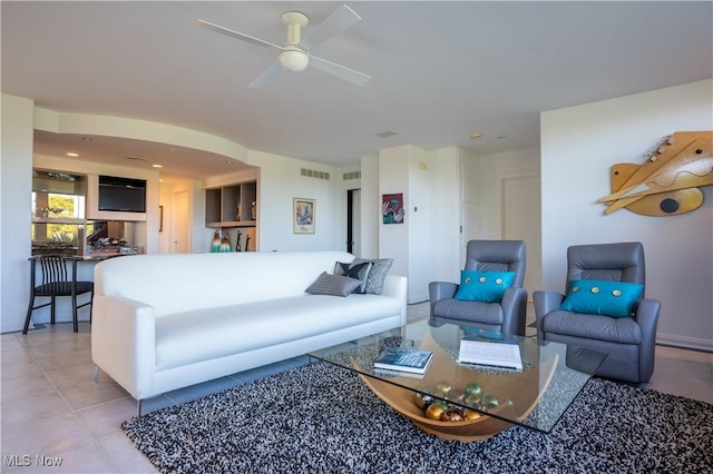 living room featuring light tile patterned floors and ceiling fan