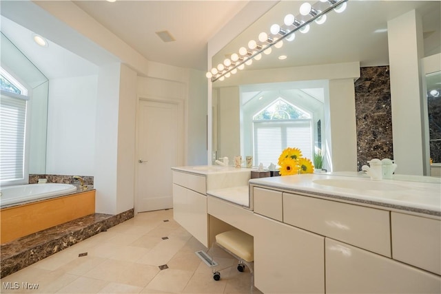 bathroom with vanity, a tub to relax in, and tile patterned floors