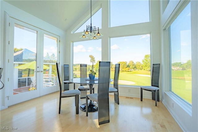 sunroom featuring lofted ceiling, a wealth of natural light, and french doors