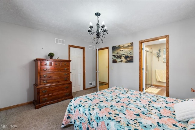 bedroom with ensuite bathroom, a textured ceiling, light carpet, and a notable chandelier