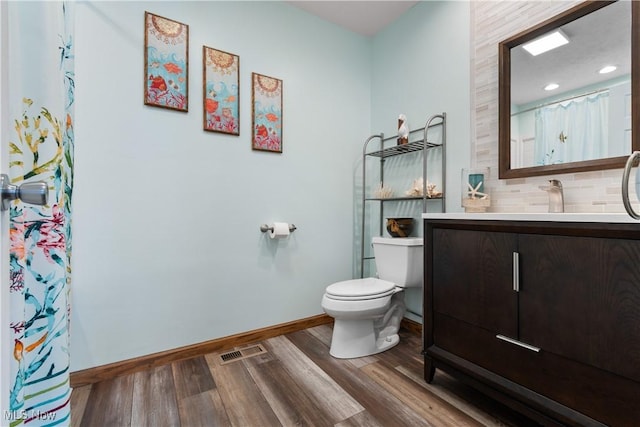 bathroom with tasteful backsplash, wood-type flooring, vanity, toilet, and a shower with shower curtain