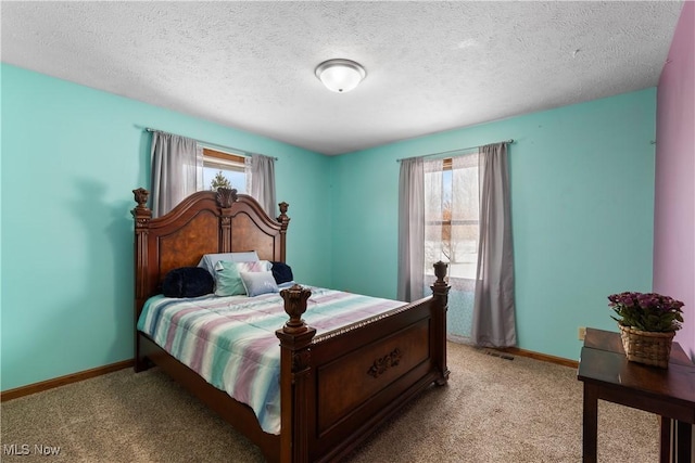 carpeted bedroom with multiple windows and a textured ceiling