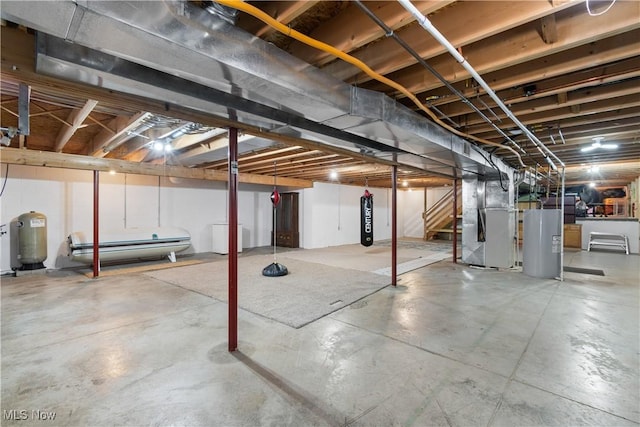 basement featuring water heater and heating unit